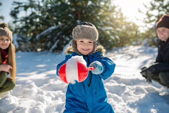 Happy cute little boy have fun in snow under parental advisory