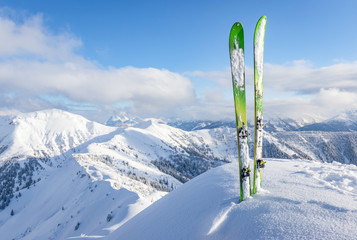 Pair of touring skis in the snow on a mountain summit
