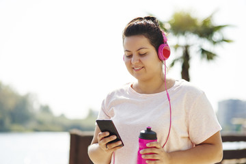 Woman choosing playlist for morning running