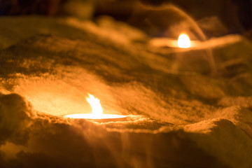 Burning candles in the snow, Christmas tradition