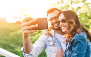 Happy smiling beautiful couple taking a selfie picture