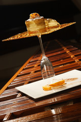 Tangerine dessert with grape sauce served on a solid caramel base.