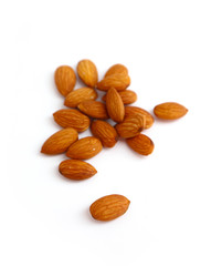 A pile of almond nuts macro view, isolated on white background.