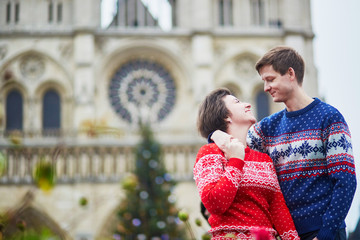 Couple on a street of Paris decorated for Christmas