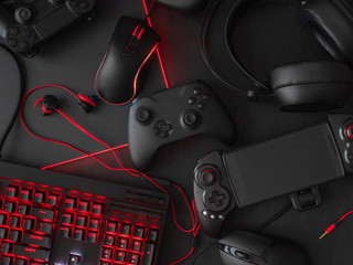 gamer workspace concept, top view a gaming gear, mouse, keyboard, joystick, headset, mobile...