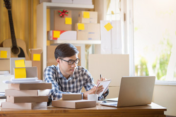 Asian man working on laptop at home