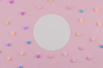 Blank round white card decorate with pastel heart on pink background