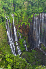 Majestic view of Tumpak Sewu Waterfall or also known as Coban Sewu, is a waterfall with 120 metres...