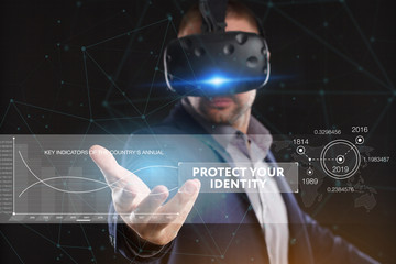 Business, Technology, Internet and network concept. Young businessman working in virtual reality glasses sees the inscription: Protect your identity