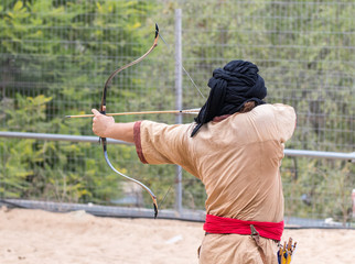 The participants of the festival in traditional costume of the Saracen warrior show the art of...