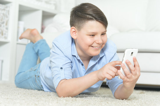 Portrait of a happy young boy with smartphone