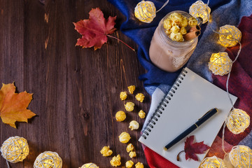 cocoa with popcorn and cinnamon on the table with an open notebook and fountain pen