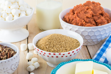 Ingredients for sweet potato casserole with marshmallows and pecans.