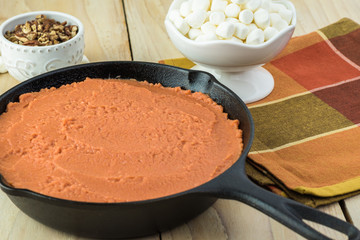 Unbaked sweet potato casserole, marshmallows and pecans for topping.