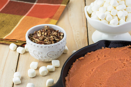 Unbaked sweet potato casserole, marshmallows and pecans for topping.