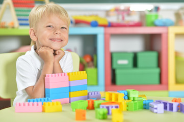 Portrait of boy playing with colorful plastic blocks