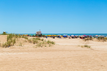 Fototapeta premium The beach and the sea. View of a beautiful beach in a sunny day of summer. The sky is intense blue.