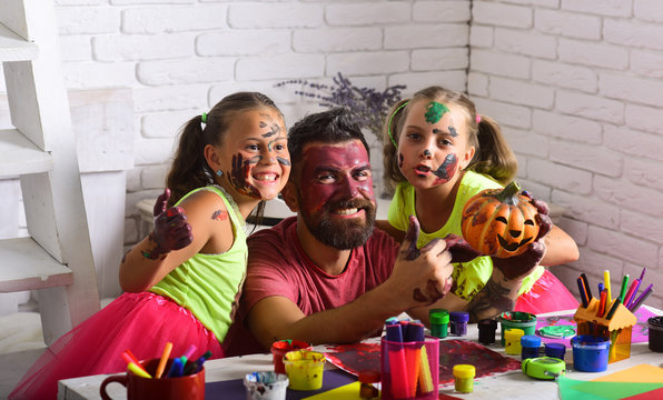 halloween family of man and girls in paint with pumpkin