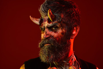 Halloween demon with bloody horns on head