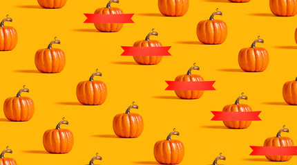 Autumn orange pumpkins on an orange background