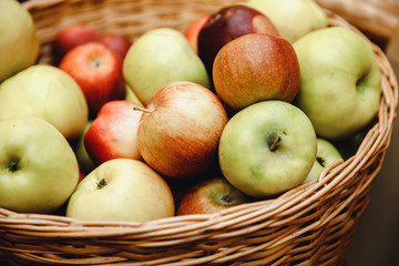 Juicy apples in rustic boxes autumn background.