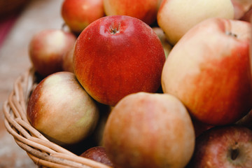 Juicy apples in rustic boxes autumn background.