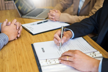 young man explaining about his profile to business managers sitting in job Interview. listen to candidate answers Hiring employee, nervously clutched scolded by boss.