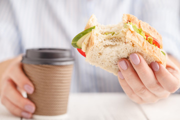 Woman working and eating at office desk