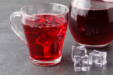 glasses of cranberry cocktail on a black stone with ice