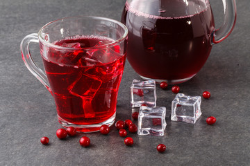 Cranberry juice and berries on a wooden surface