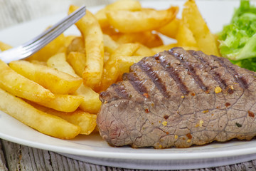 grilled steak with potatoes and vegetables