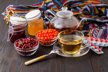 Healing tea from dried flowers of linden and dogrose  and fresh berries and honey is used in folk medicine