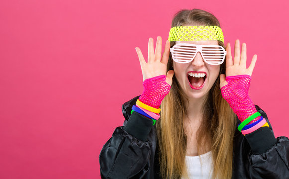 Woman In 1980's Fashion Theme On A Pink Background