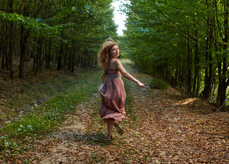 Scared girl running through forest
