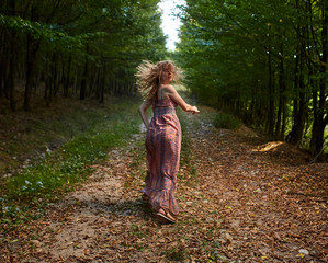 Scared girl running through forest