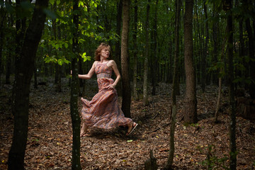 Scared girl running through forest