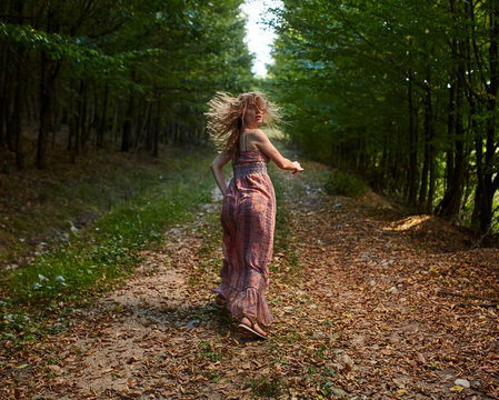 Scared girl running through forest