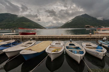 Fototapeta na wymiar Boats at see before the storm with dramatic clouds in background