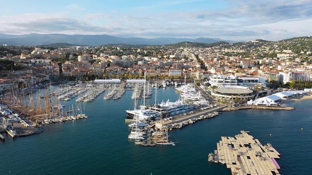 Aerial panoramic view of cityscape of Cannes, famous city on French Riviera during sunset, yachts in harbour - Mediterranean sea, France, Europe