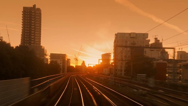 Sunset POV shot of a train journey through the center of the financial district in London, England, UK