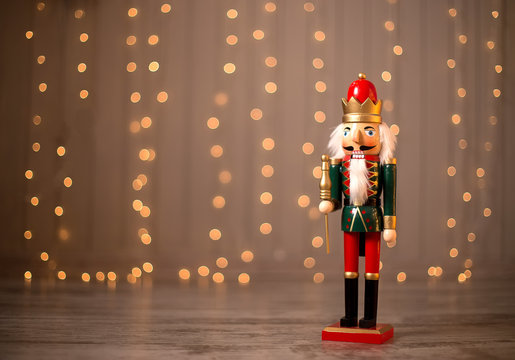 Toy nutcracker on a festive background