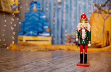 Toy nutcracker on a festive background