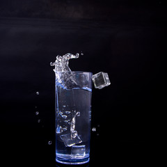 water splash in glass isolated on black bacgraund