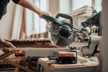 The joiner's hands are controlled by a circular electric saw cut-out for cutting a tree