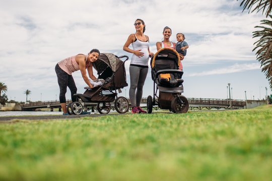 Mothers on a morning walk with their kids in baby prams