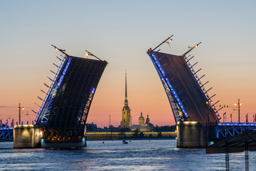 Fototapeta na wymiar White nights in Saint-Petersburg - view on The Peter and Paul fortress through the opening Palace bridge.