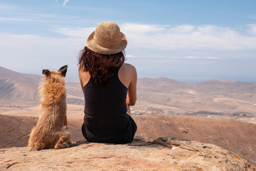 girl watching the panorama with her puppy dog