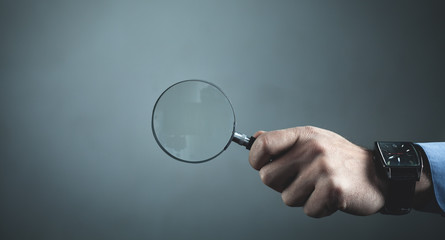 Hand showing magnifier. Business concept