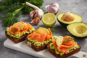 Sandwiches with avocado spread and smoked salmon.