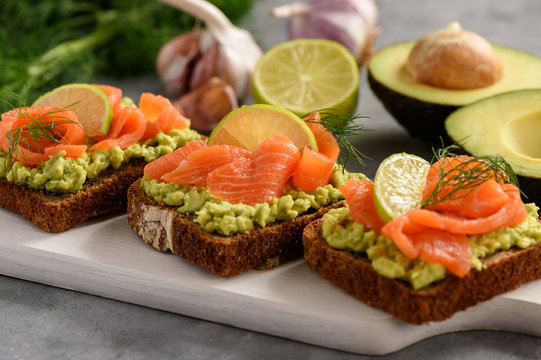 Sandwiches with avocado spread and smoked salmon.